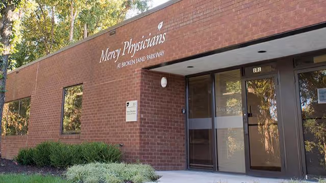 Brick medical clinic building with Mercy Physicians at Broken Land Parkway sign and glass entrance.