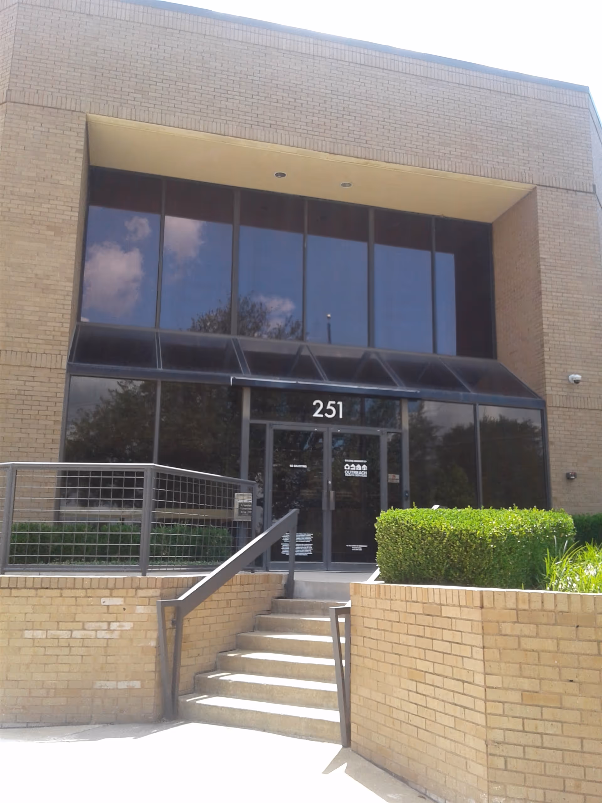 Outreach Health building entrance with glass doors and stairs.