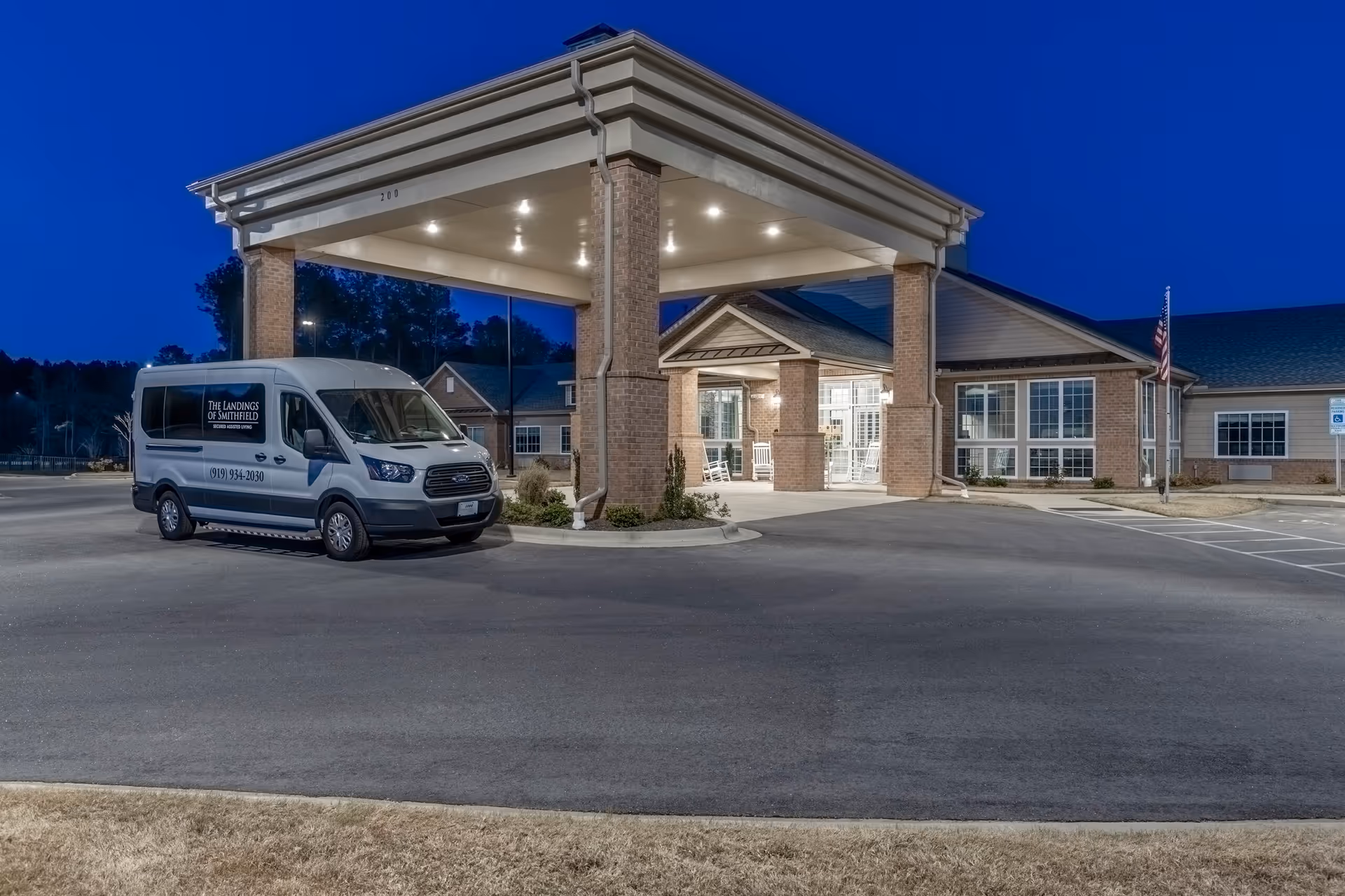 Exterior view of The Landings of Smithfield entrance with a parked van.