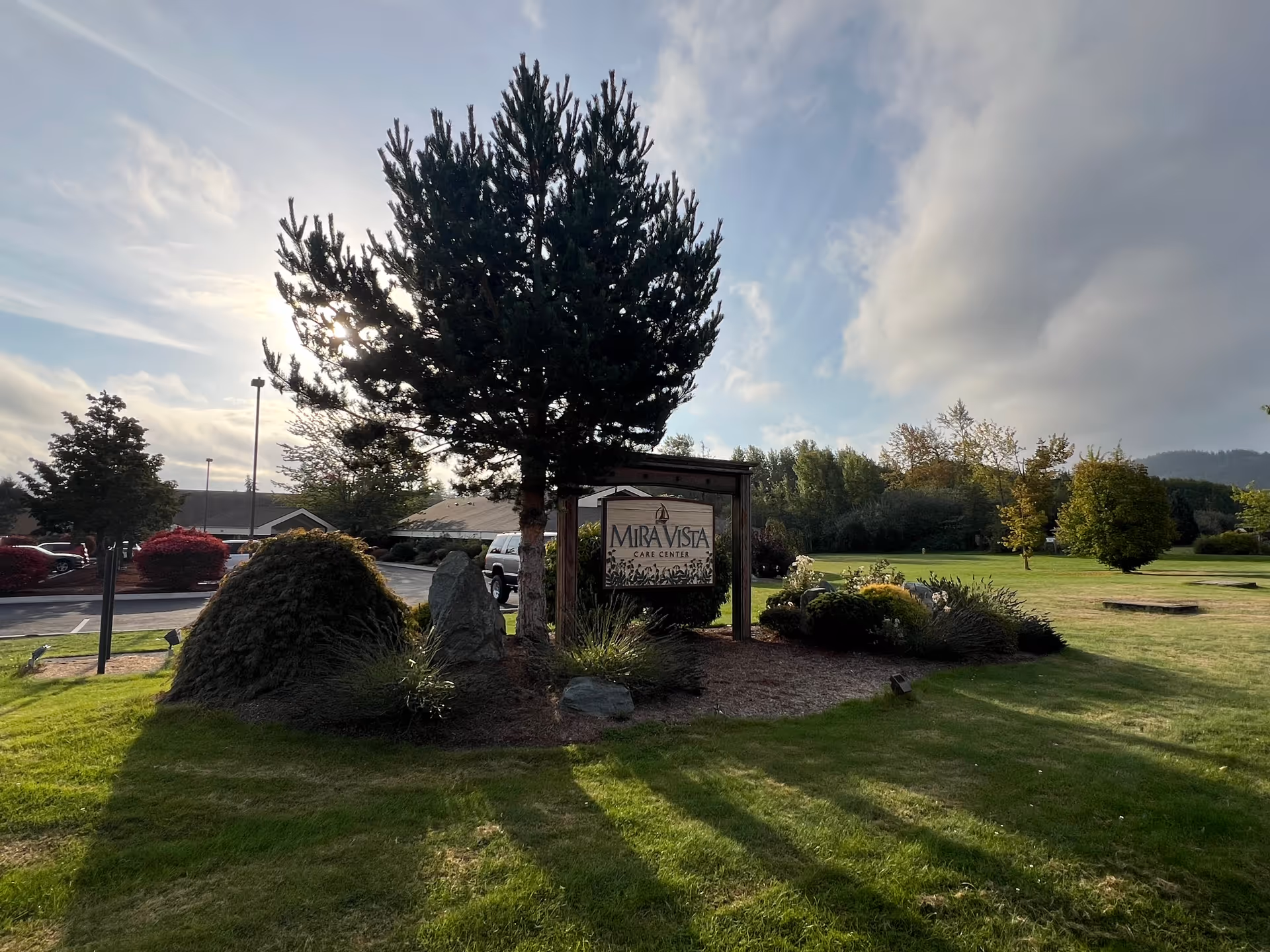 Exterior view of Mira Vista Care Center entrance with landscaped lawn and sign.