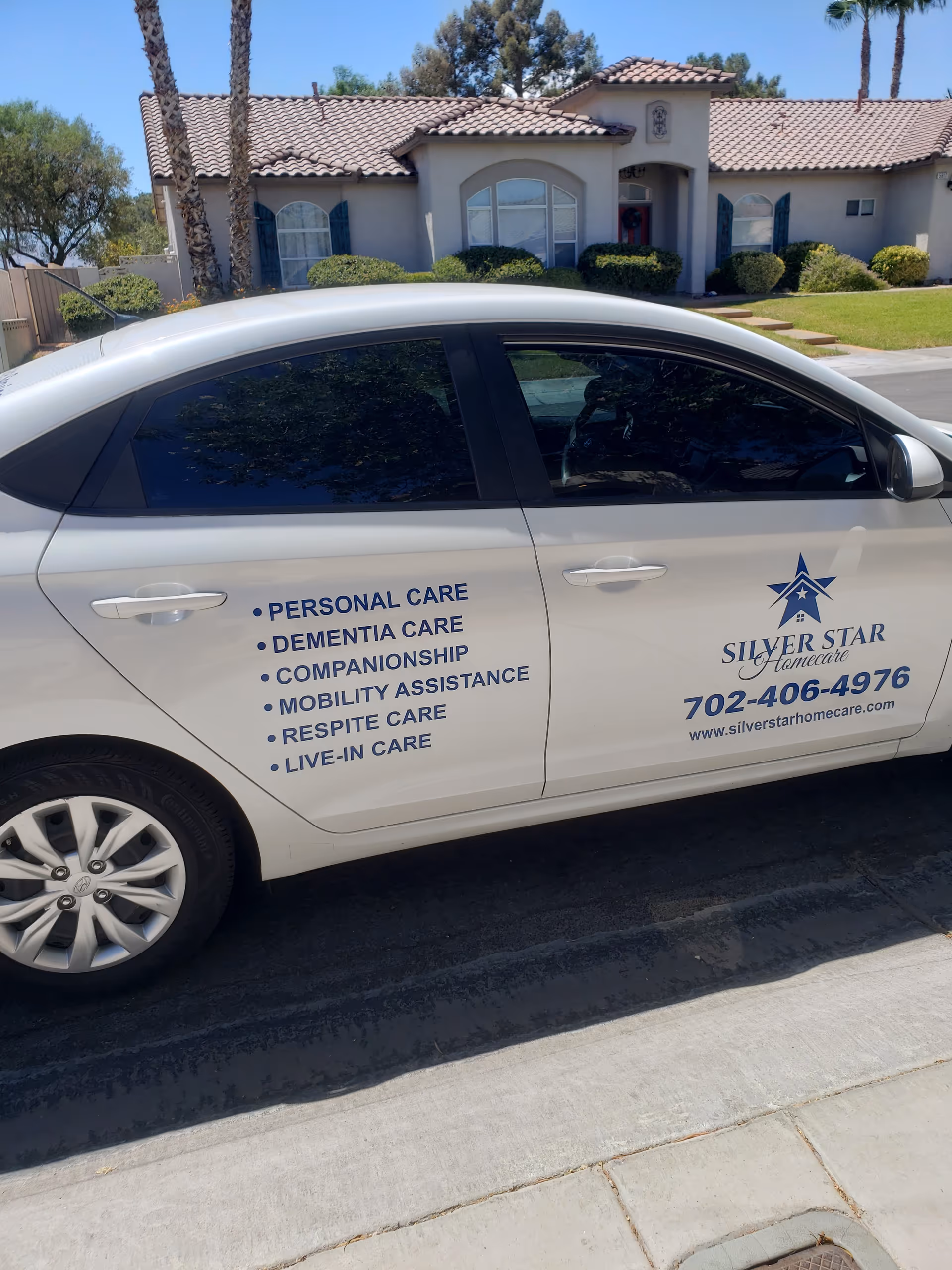 White Silver Star Homecare van parked in front of a suburban house.