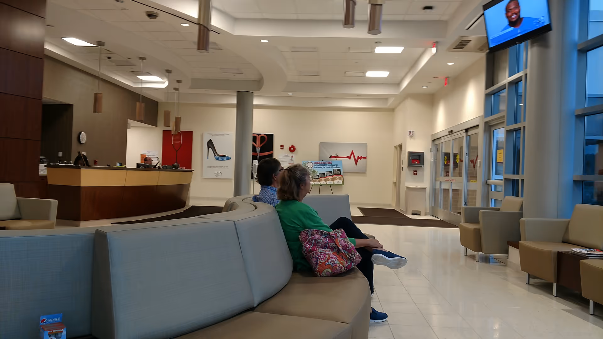 Knapp Cardiac Care Center lobby with curved gray seating, reception desk, and large windows.