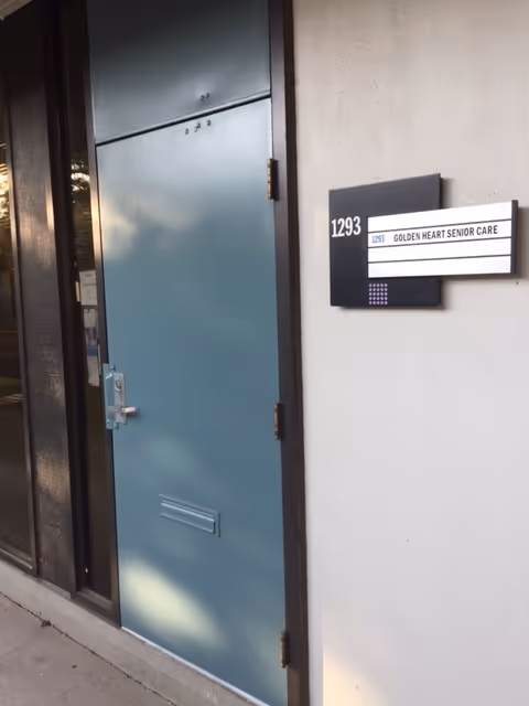 Blue door at a facility entrance with sign reading Golden Heart Senior Care.