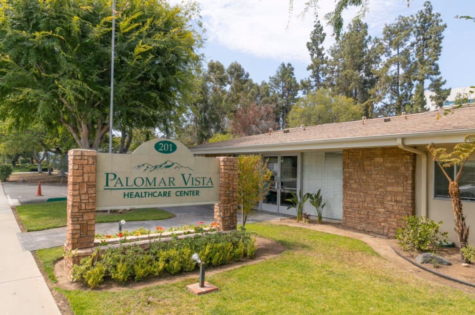 Exterior view of Palomar Vista Healthcare Center with sign and entrance