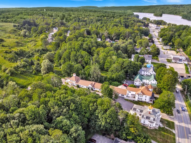 Aerial view of Captain Lewis Residence campus surrounded by trees beside a lake.