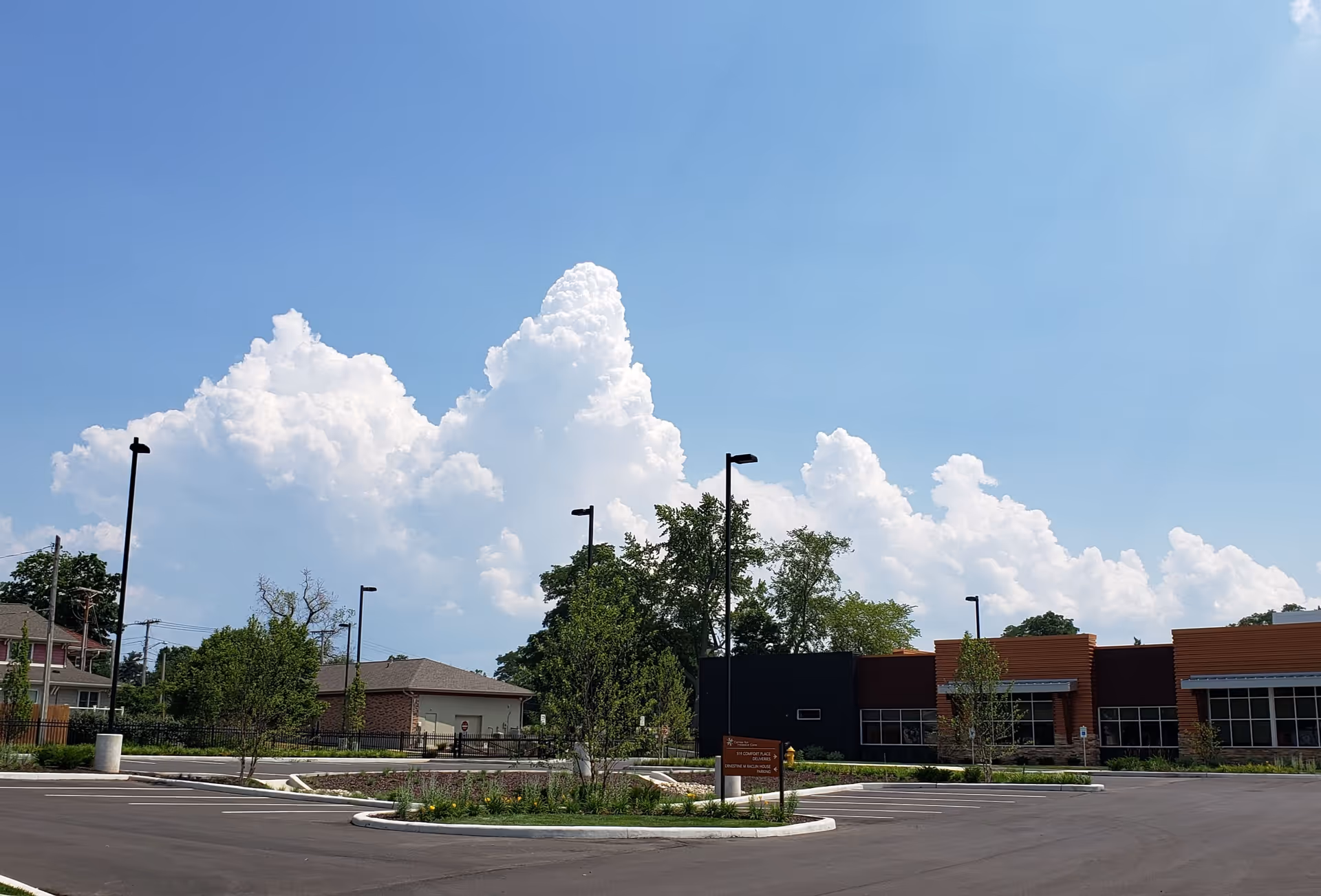 Exterior view of Center for Hospice Care building with parking lot and blue sky.