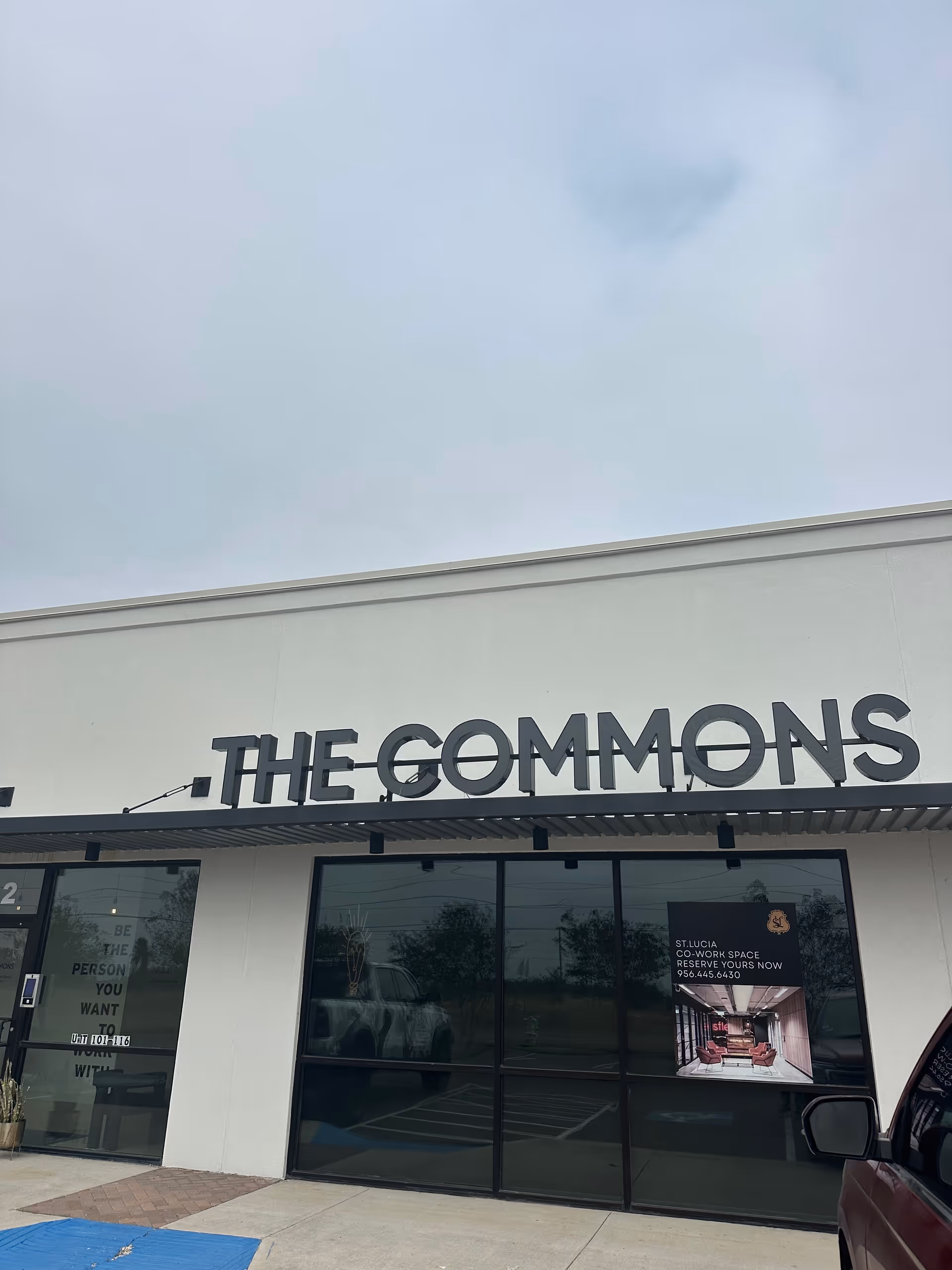 Exterior view of a storefront with The Commons sign on the building.