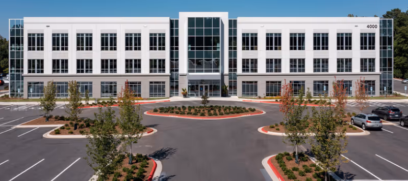 Amivie Corporate Office building with glass entrance and circular driveway.