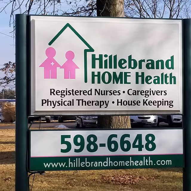 Outdoor sign for Hillebrand Home Health showing services and phone number.