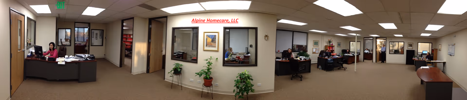 Panoramic view of a busy reception area with desks and staff.