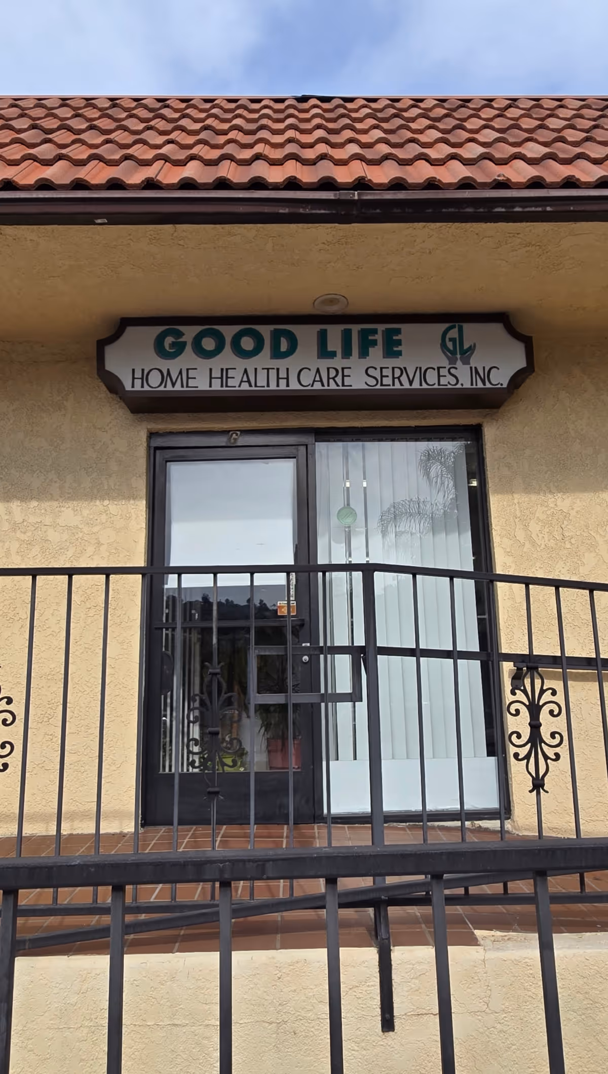 Exterior view of Good Life Home Health Care Services, Inc. entrance with railing and sign.
