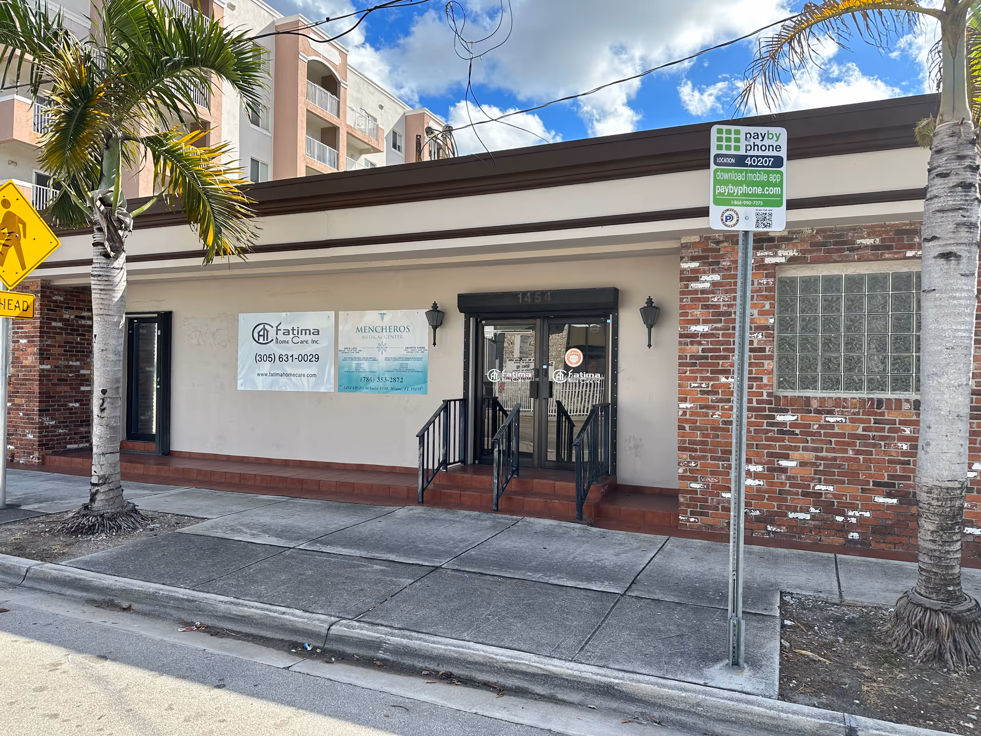Front exterior of Fatima Home Care Inc building with signage and palm trees.
