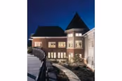 Evening exterior view of Landis Homes senior living building with landscaped surroundings.
