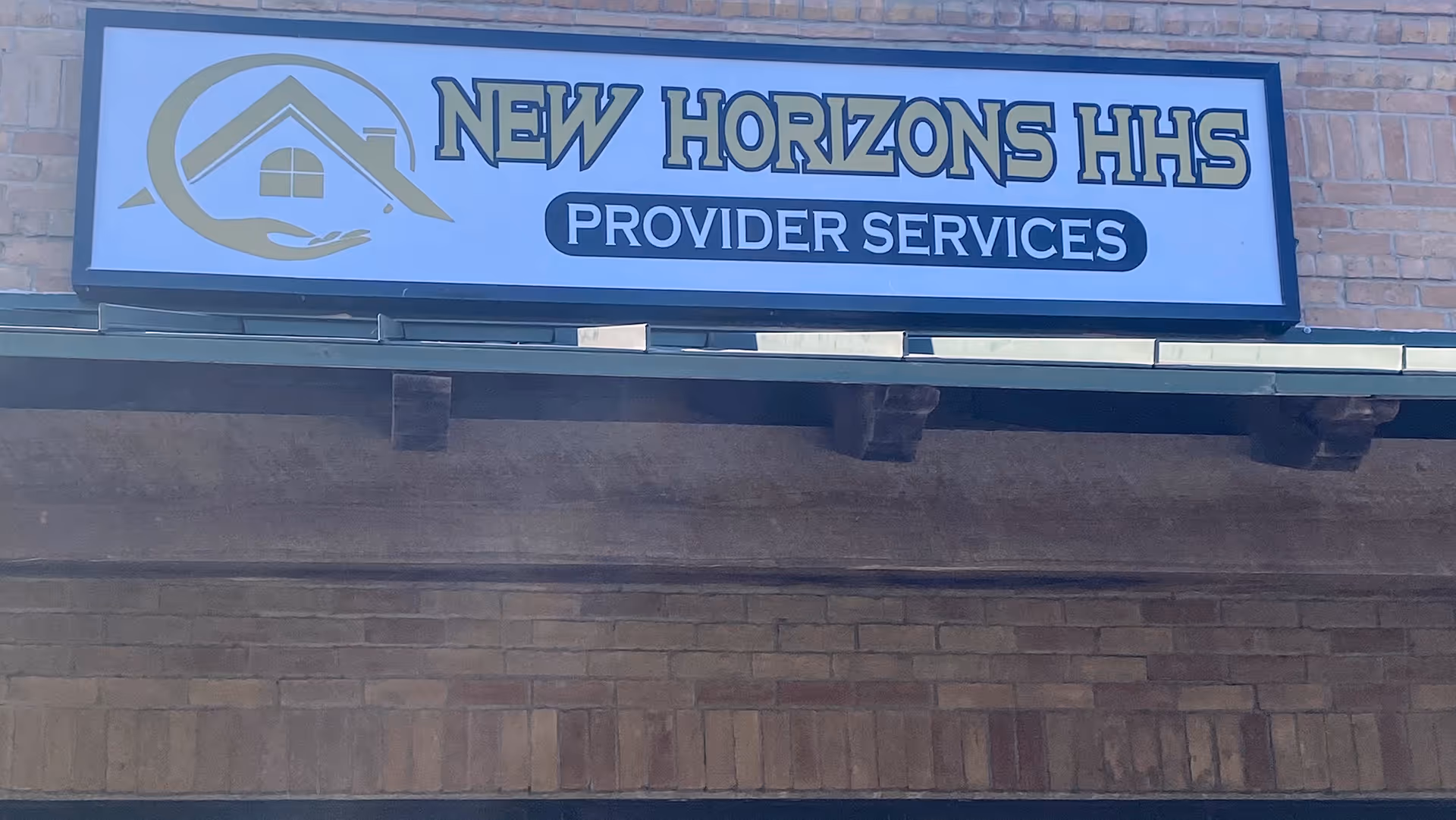 Exterior brick building with a New Horizons HHS Provider Services sign and logo.