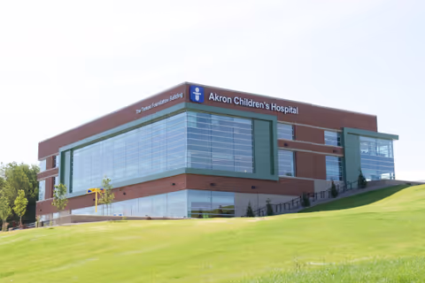 Exterior view of Akron Children's Hospital Adolescent Medicine building on a grassy hill.