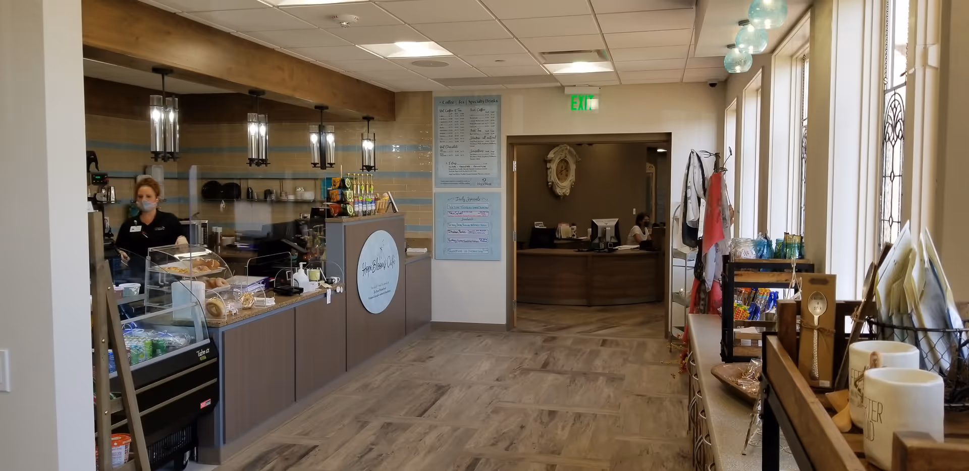 Reception area of a senior living center with a cafe counter and menu board.