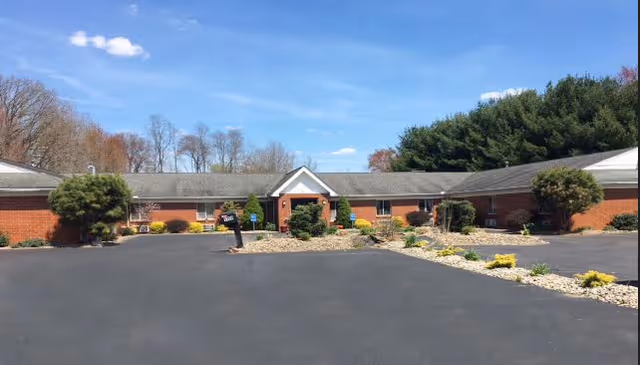 Grace Woods Assisted Living - Salem exterior with central entrance and landscaped front parking.