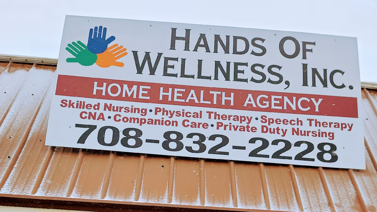 Exterior building sign reads Hands Of Wellness, Inc. Home Health Agency with phone number.