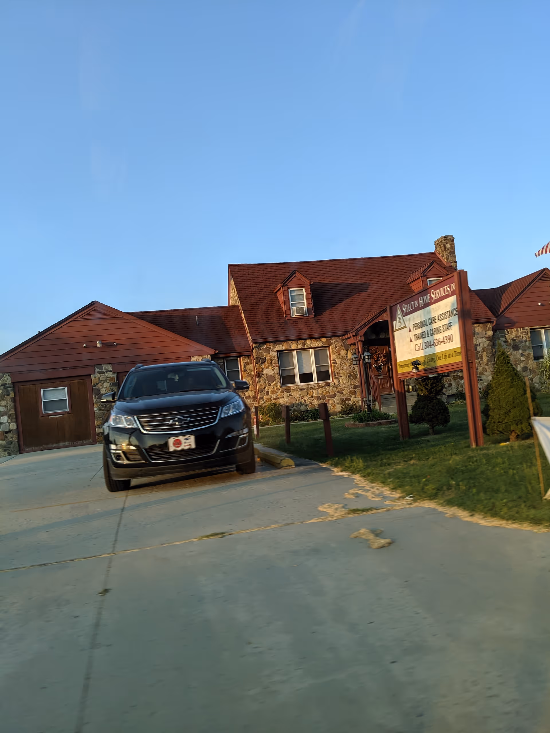 Exterior view of Select In Home Services facility with a parked SUV.