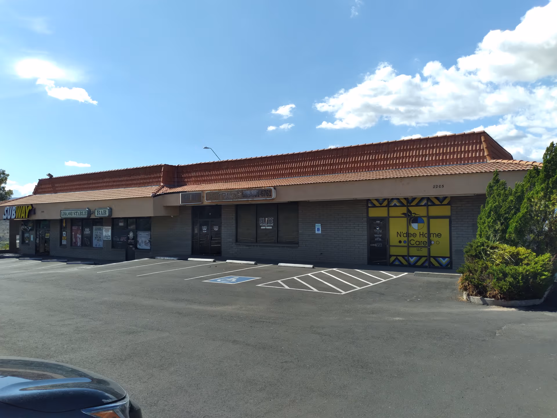 Exterior view of a strip mall with N'dee Home Care LLC signage and parking.