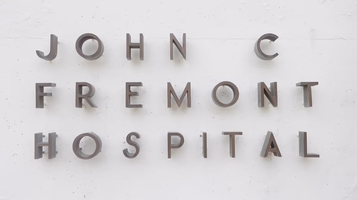 Exterior wall with metal letters spelling John C Fremont Hospital.