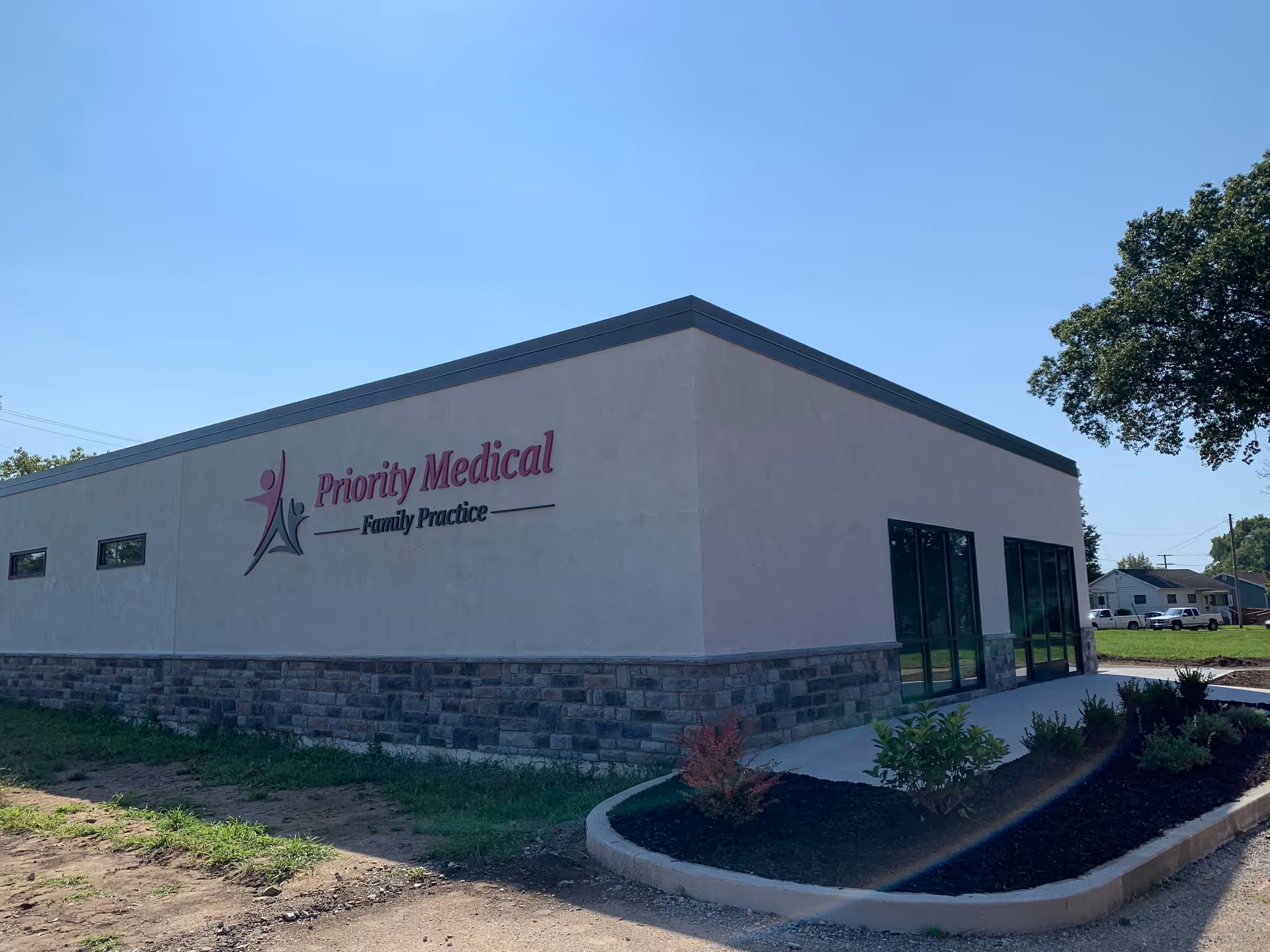 Exterior view of a single-story medical clinic building with Priority Medical Family Practice sign.