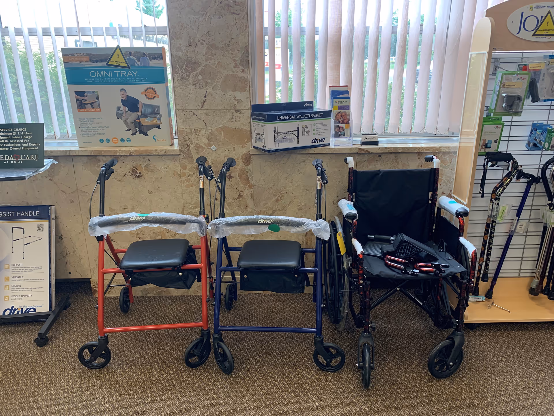 Indoor display of mobility aids such as walkers and a wheelchair along a showroom wall.