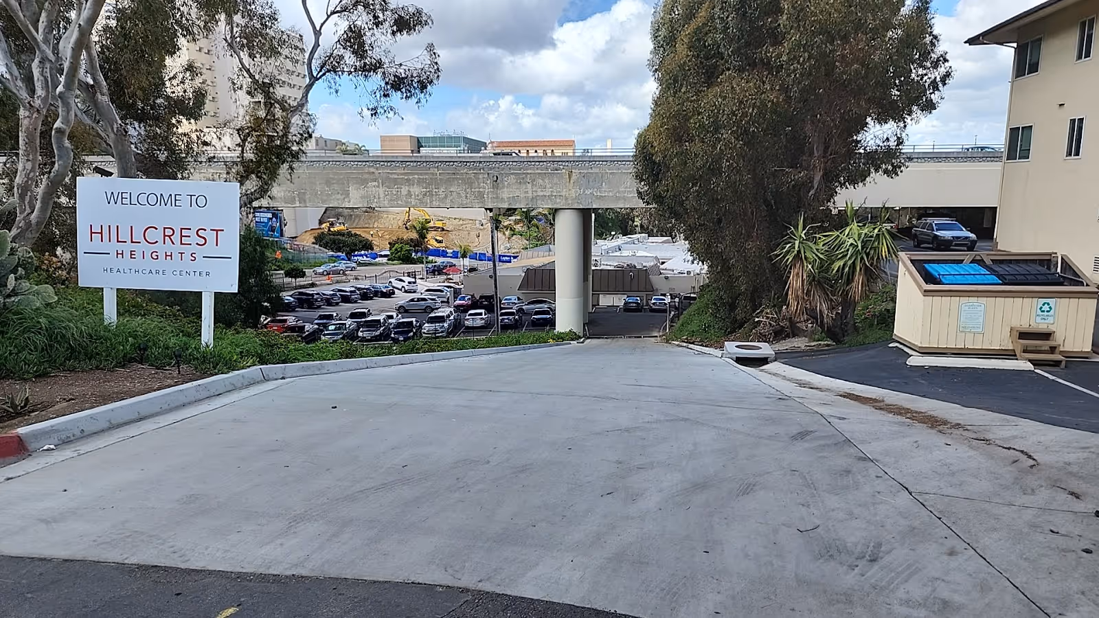 Wide driveway leads to Hillcrest Heights Healthcare Center entrance with sign and parking.