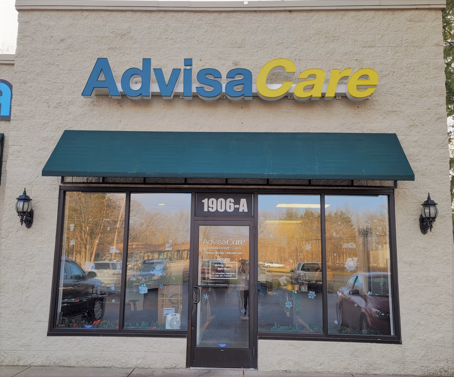 Exterior view of AdvisaCare storefront with green awning and glass entrance