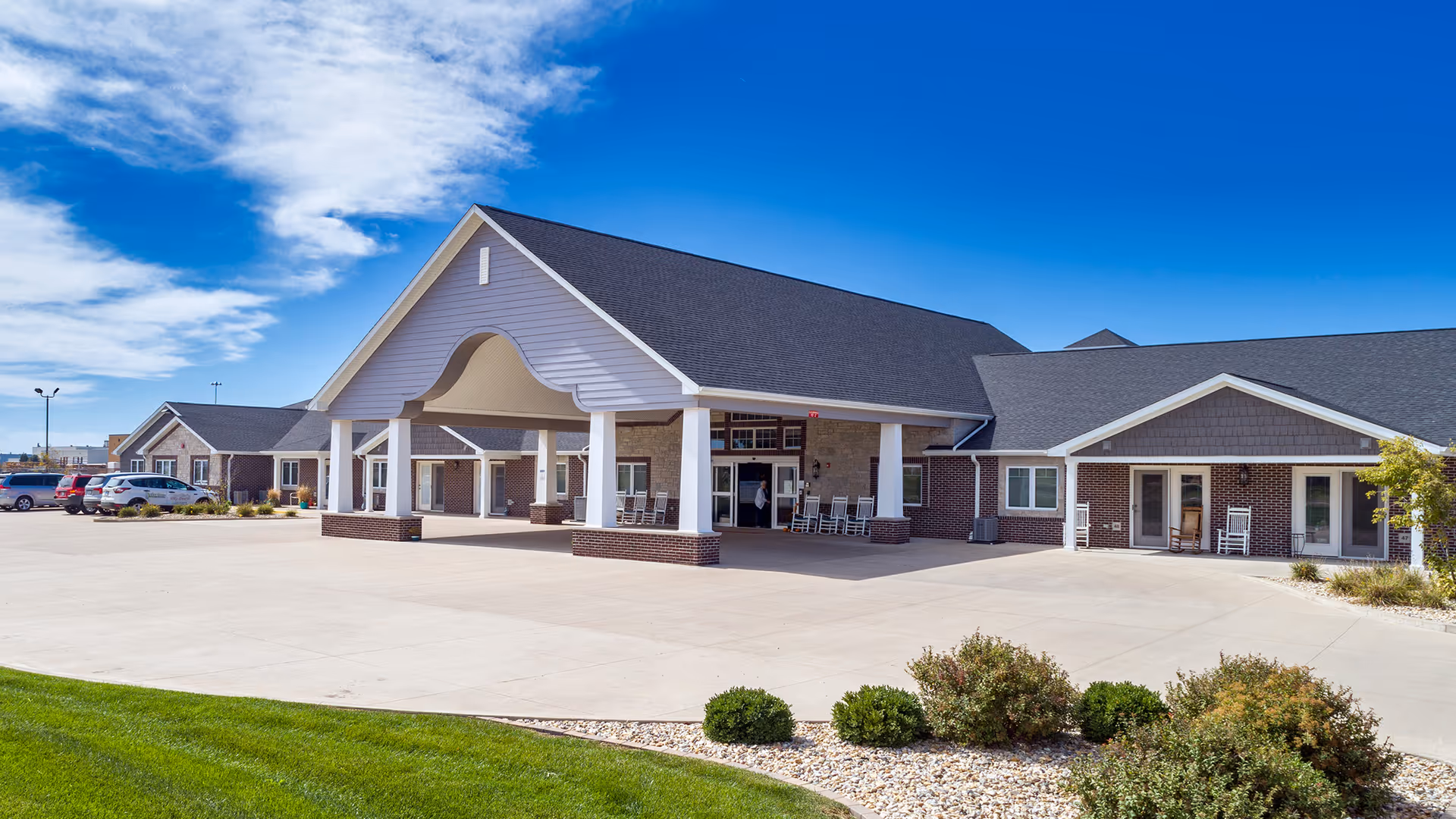 Front view of Villas of Holly Brook Morton entrance with covered canopy and brick facade.