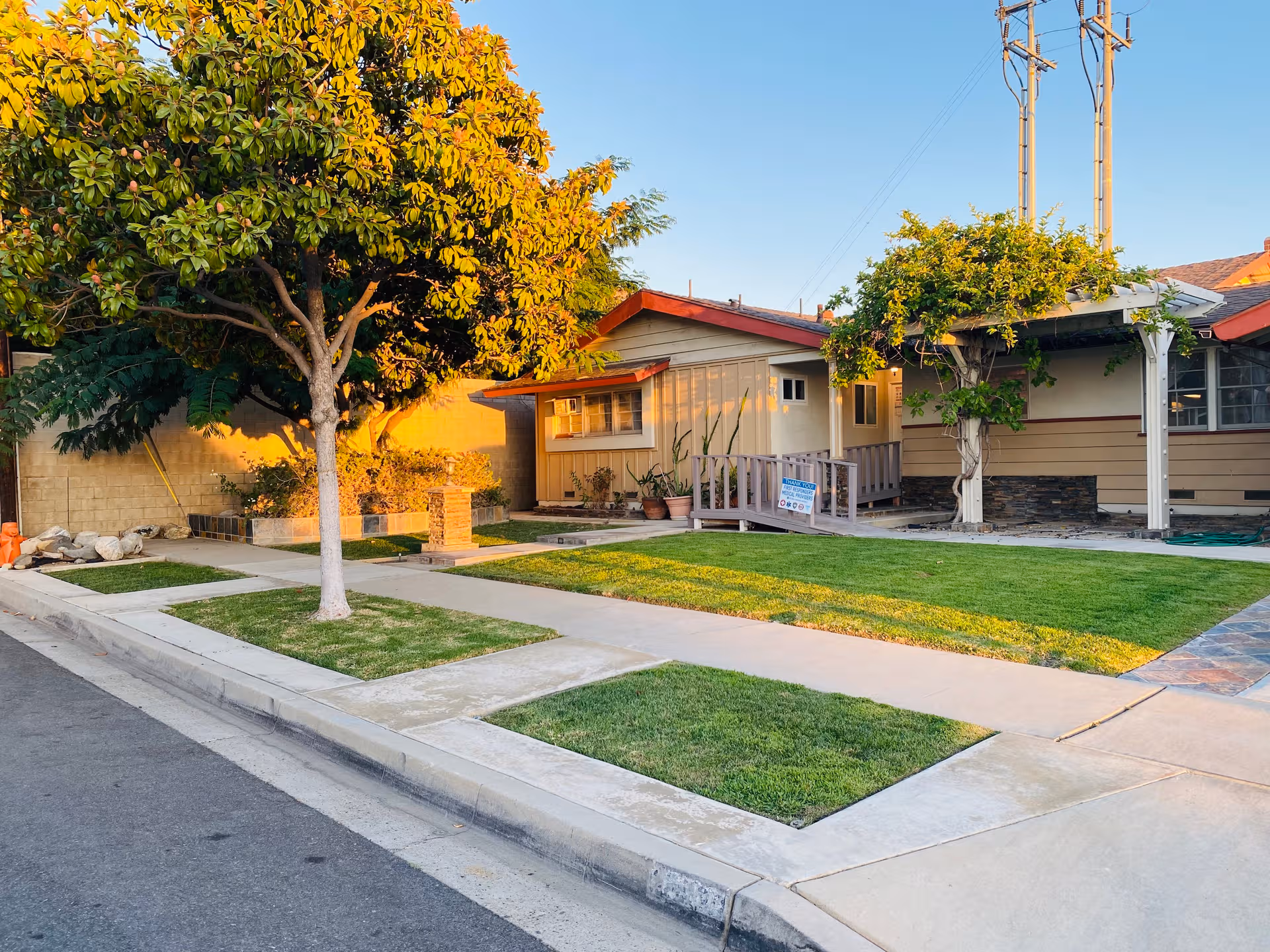 A Care Vanna facility exterior with a manicured lawn and trees.