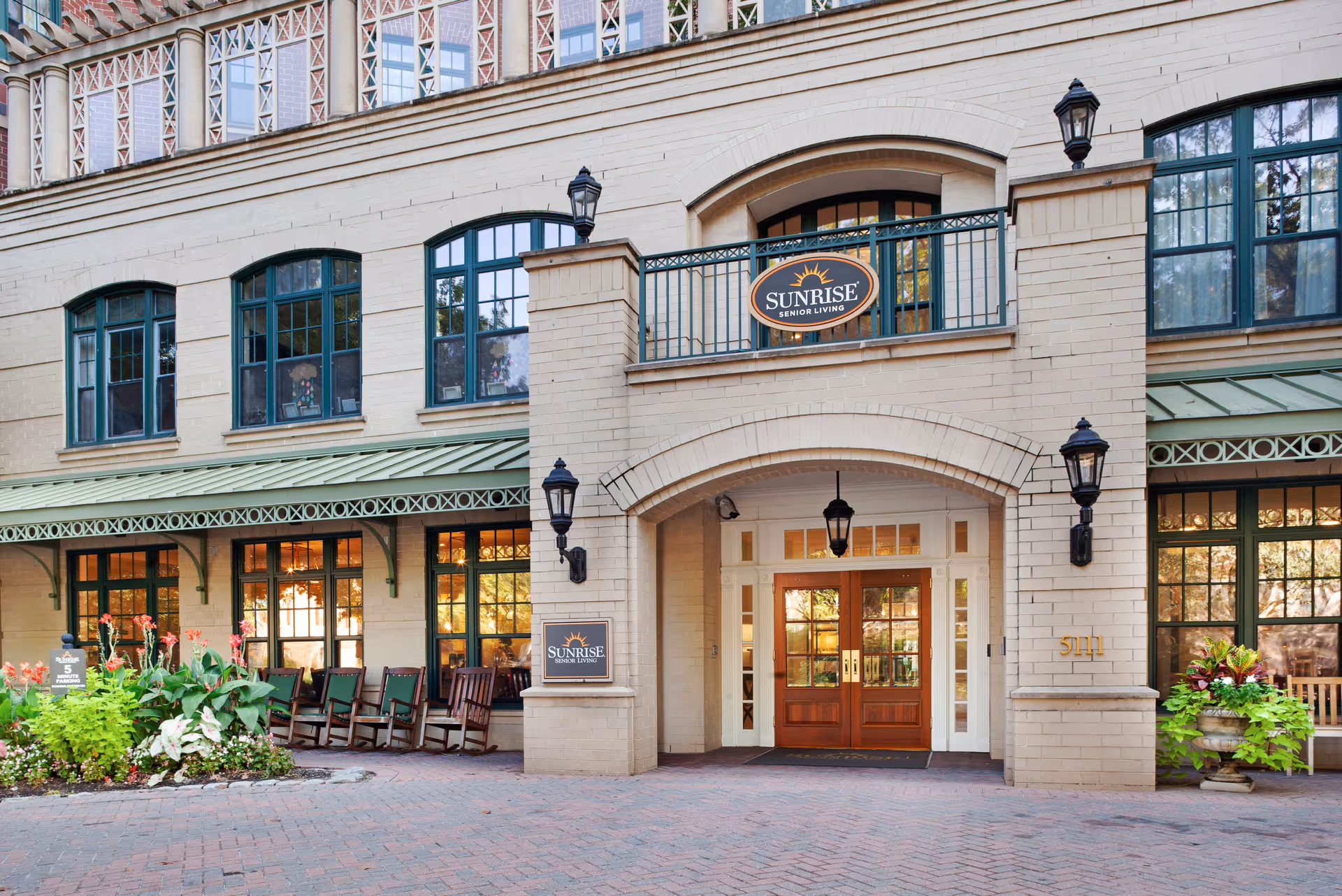 Front view of Sunrise on Connecticut Ave senior living facility with entrance and outdoor seating.