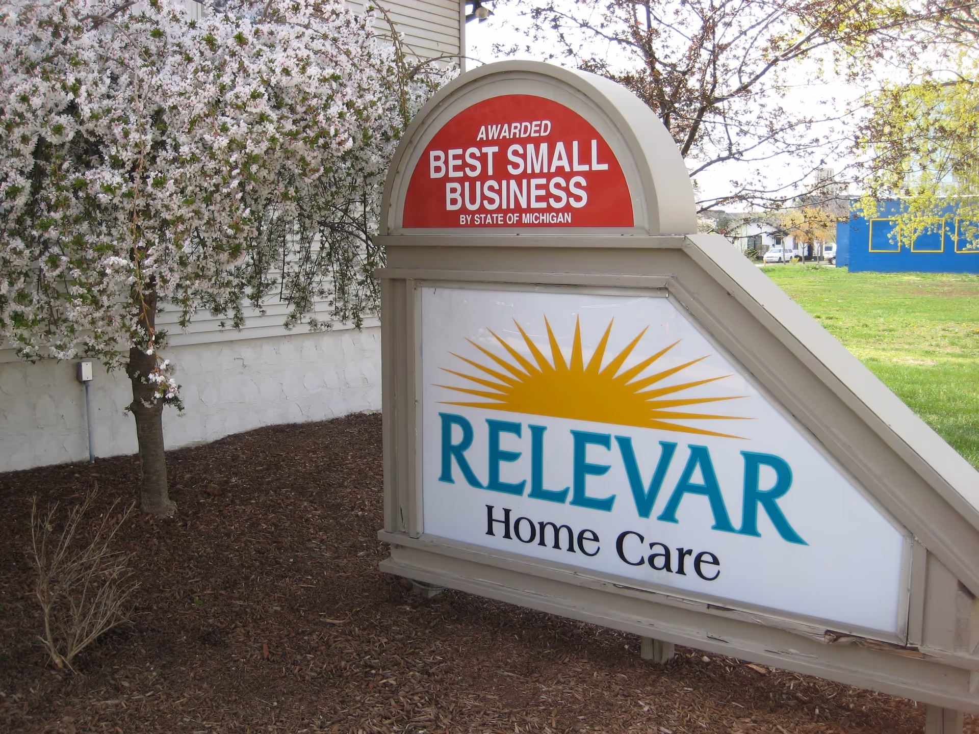 Exterior sign reads RELEVAR Home Care with a Best Small Business award arch