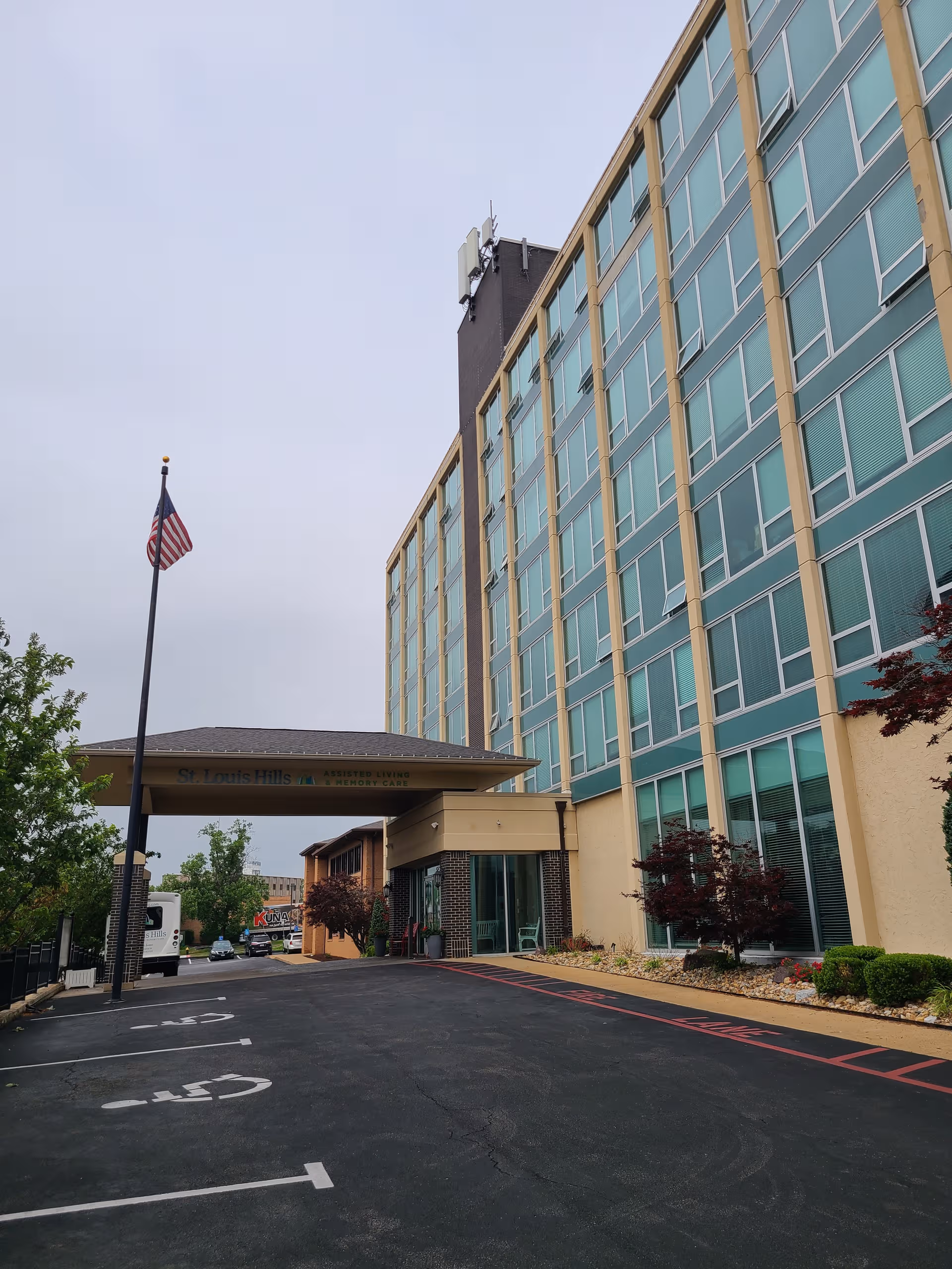 Exterior view of a multi-story assisted living building with entrance canopy.