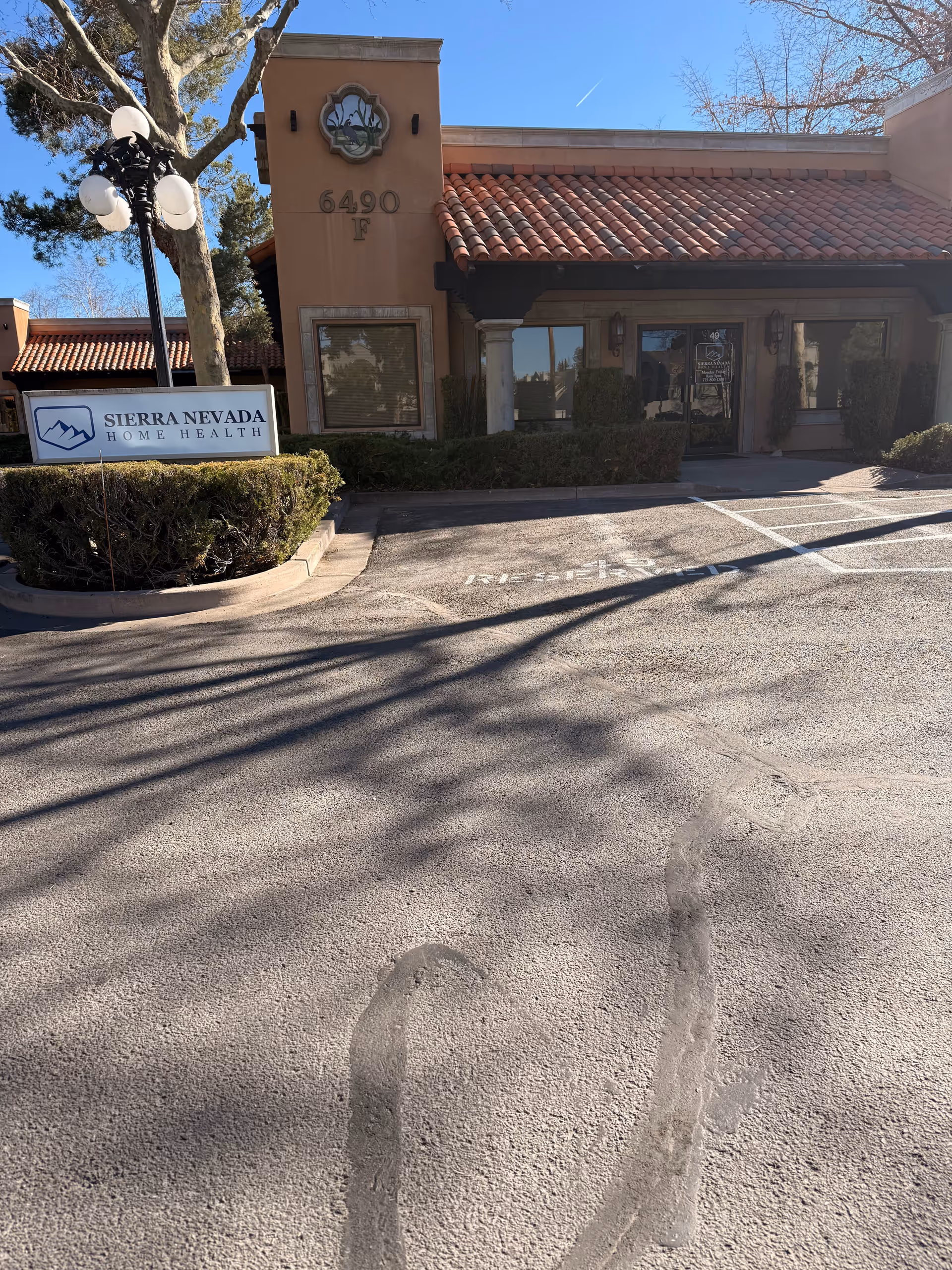 Exterior view of Sierra Nevada Home Health facility with tiled roof and entrance.