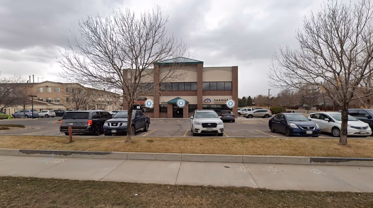 Front view of Adara Home Healthcare building with a parking lot and leafless trees.