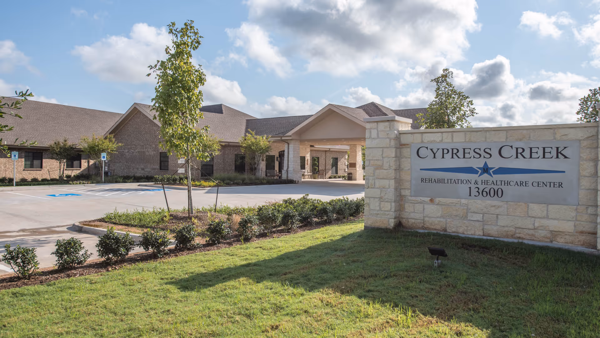 Exterior view of Cypress Creek Rehabilitation and Healthcare Center with entrance sign and parking lot