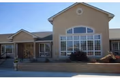 Front view of Brookside Retirement Community building with large arched window and entrance steps.