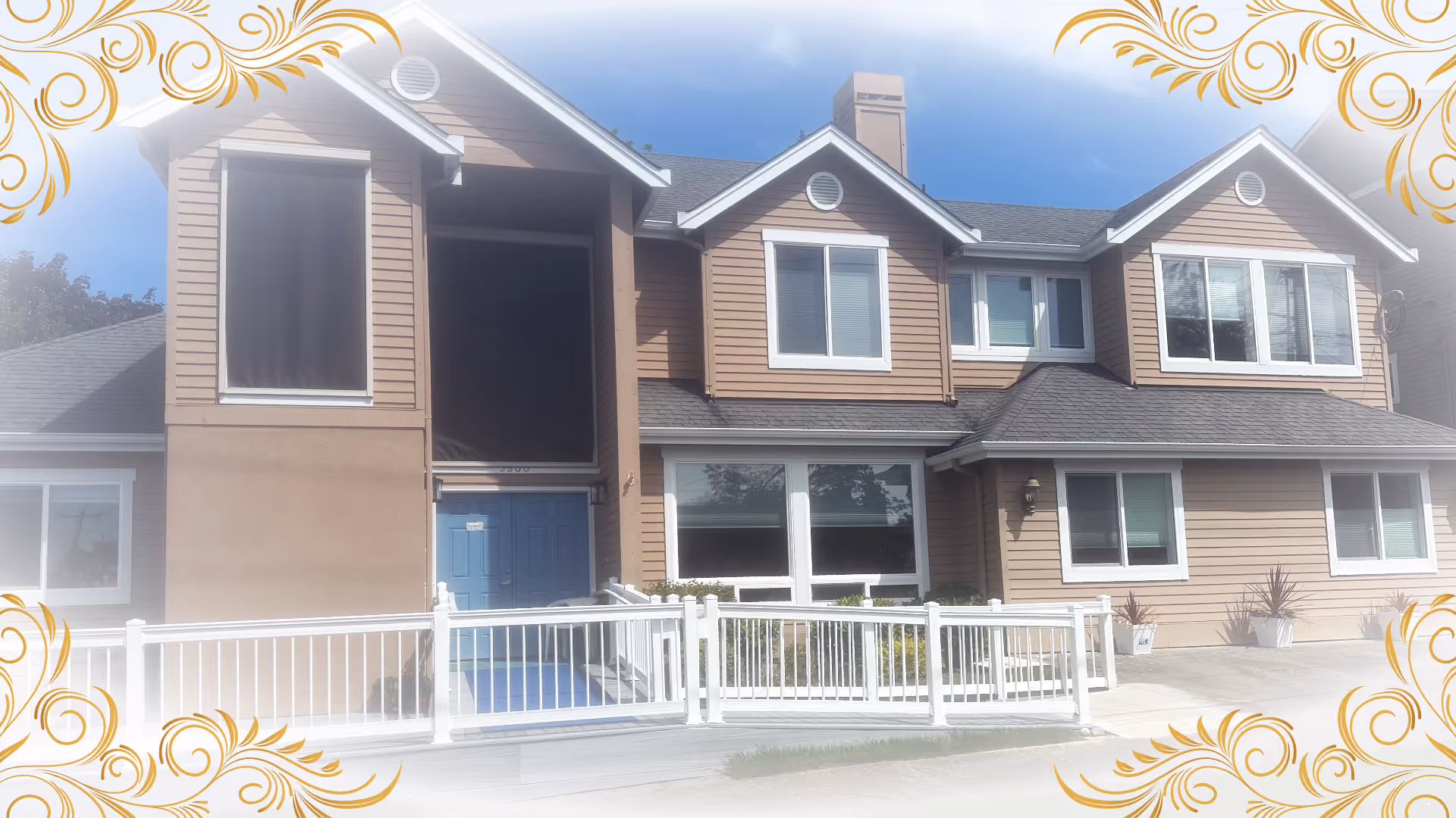 Two-story brown-siding senior living facility with white trim, large windows, and a blue front door.