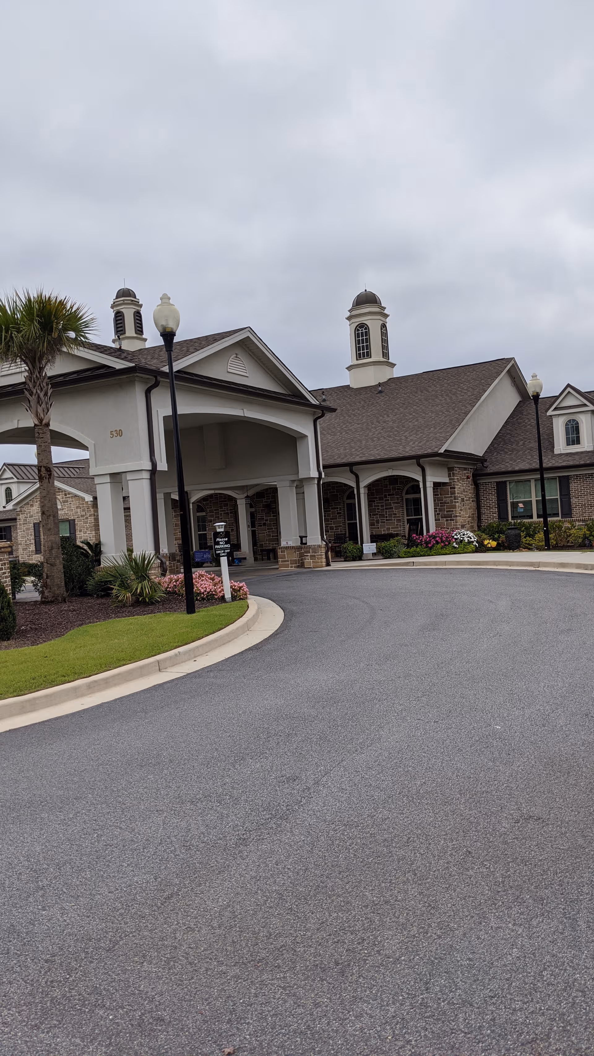 Exterior view of Benton House of Aiken entrance with curved driveway and landscaped grounds.