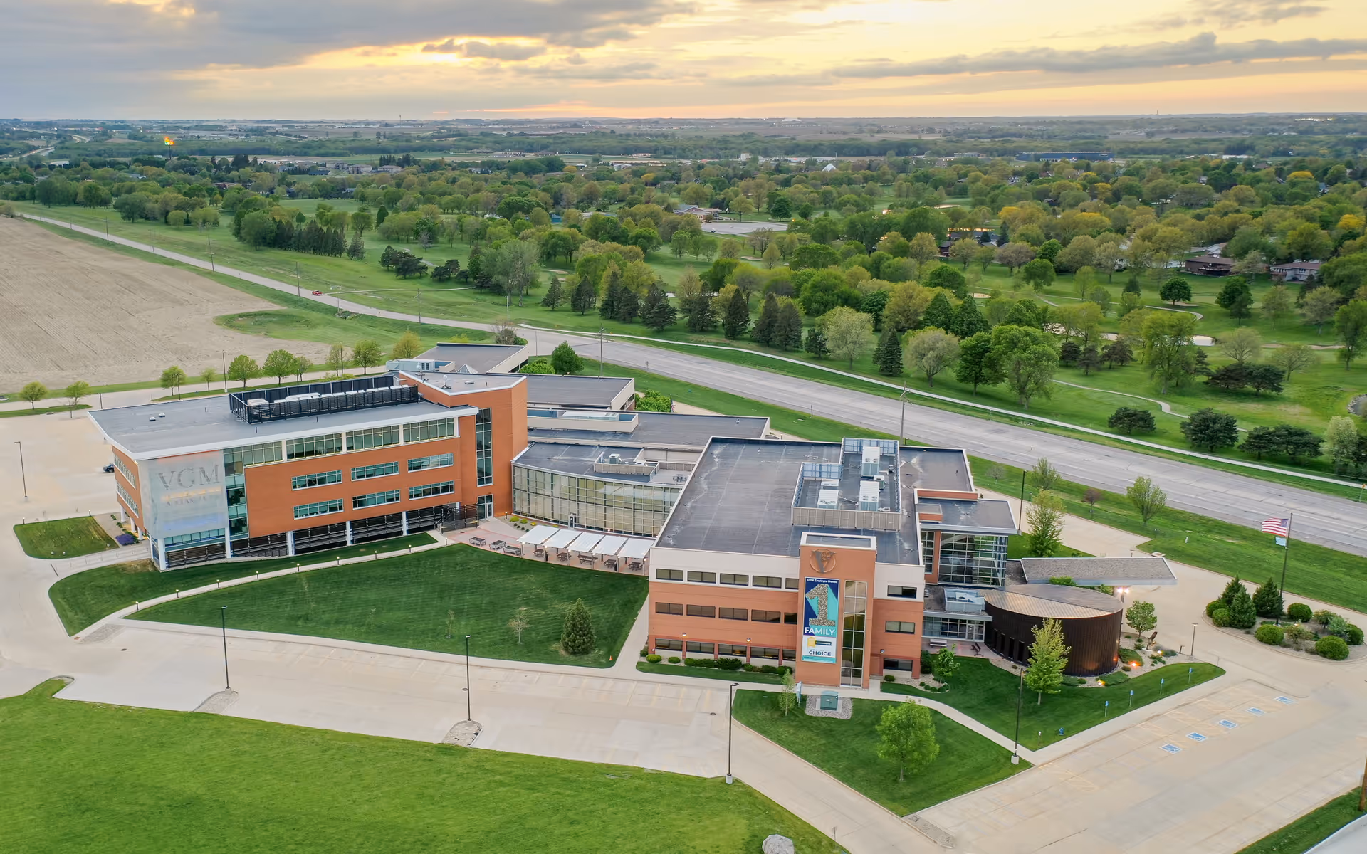 Aerial view of a modern senior living campus with expansive lawns and roads.