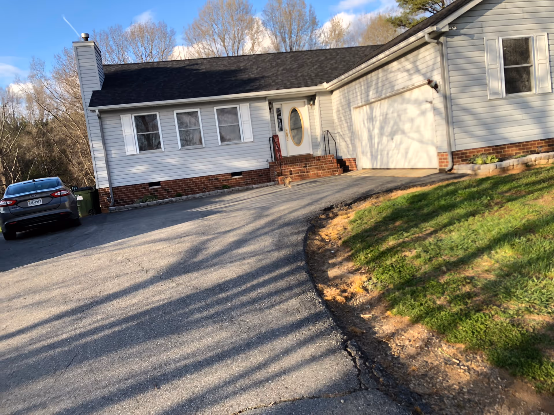 Front view of Windy Hill Retreat Elderly Care Home with driveway and parked car.
