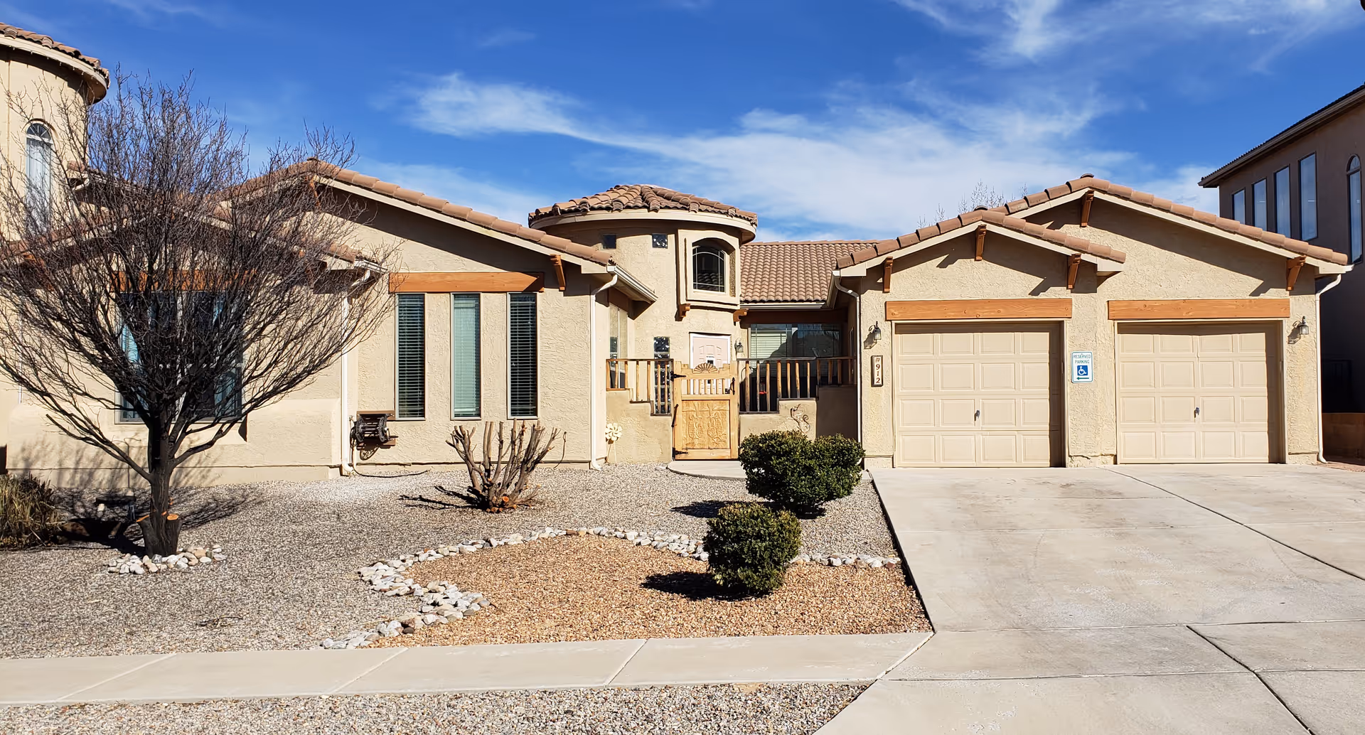 Front view of Sandia View Assisted Living building with a three-car garage.