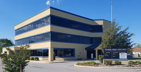 Exterior view of Beebe Healthcare Home Health Services building with beige walls and blue windows.
