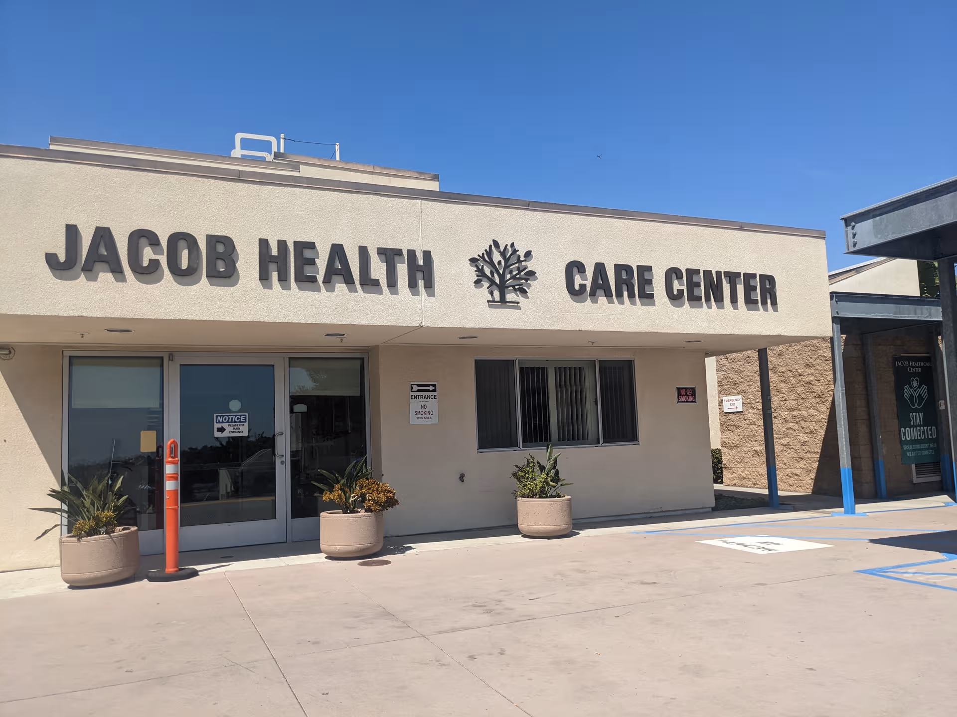 The Jacob Health Care Center building front with sign and entrance doors.