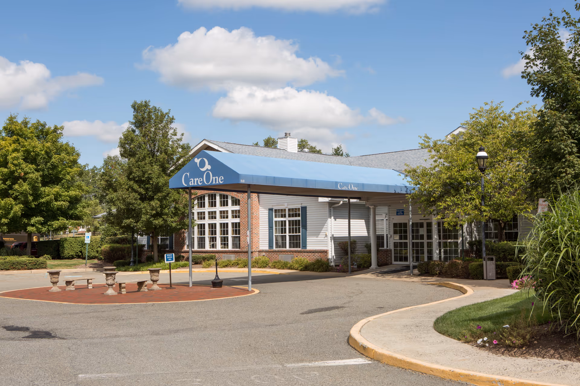 Care One at Morris exterior entrance with blue awning and brick plaza.