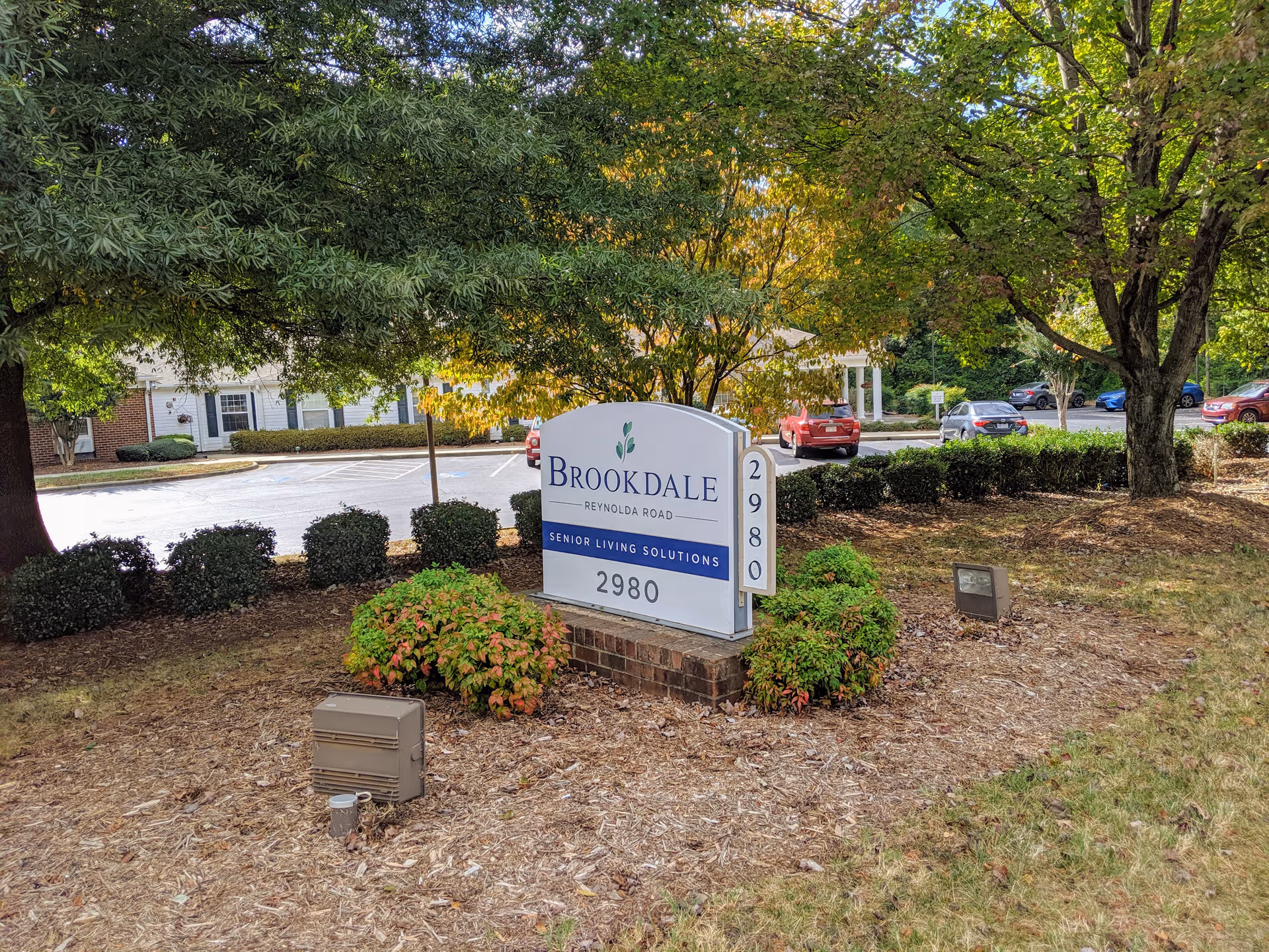Brookdale Reynolda Road exterior sign surrounded by trees and landscaped front yard.