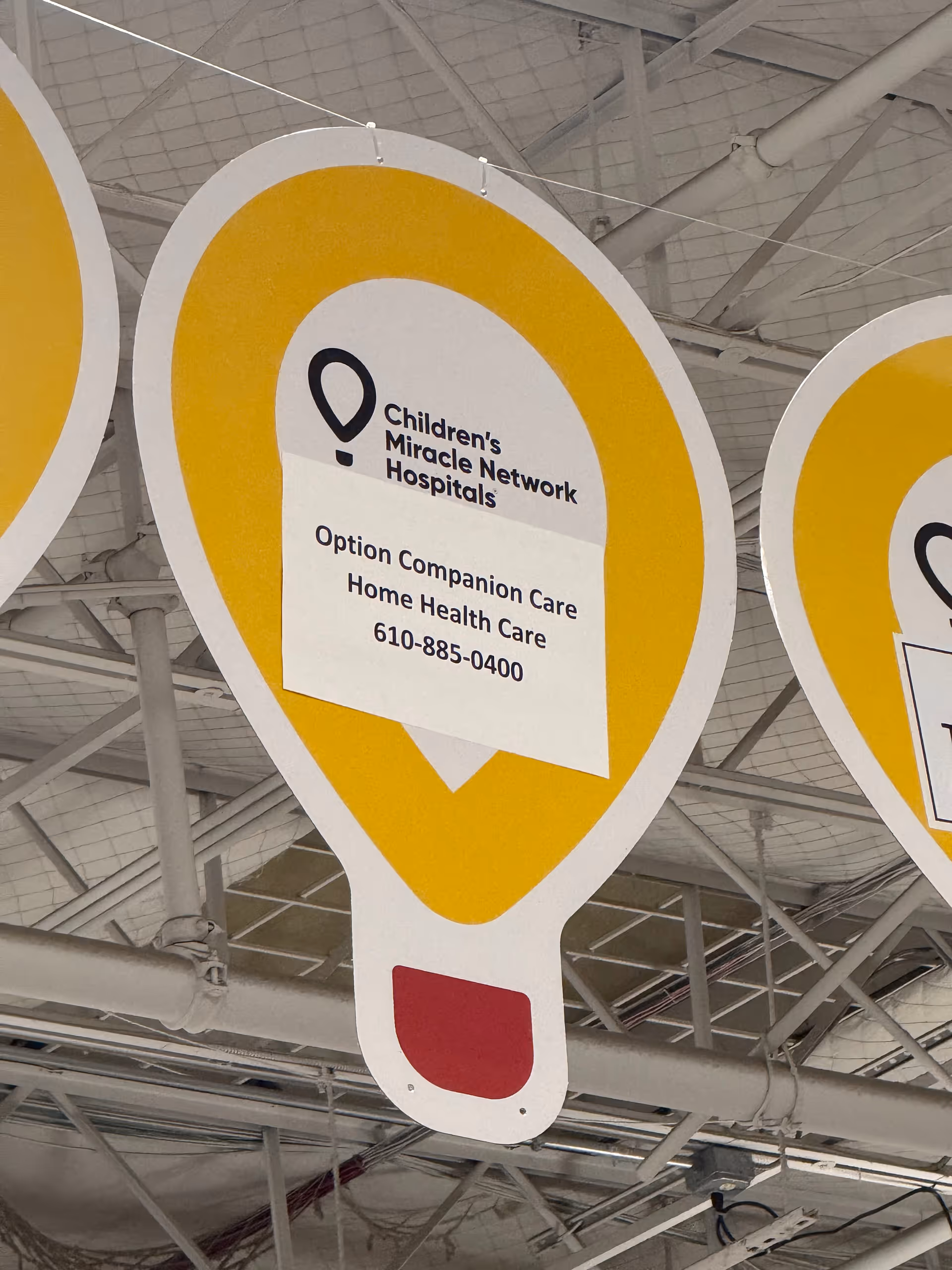 Interior ceiling with large yellow sign reading Option Companion Care and home health contact details.