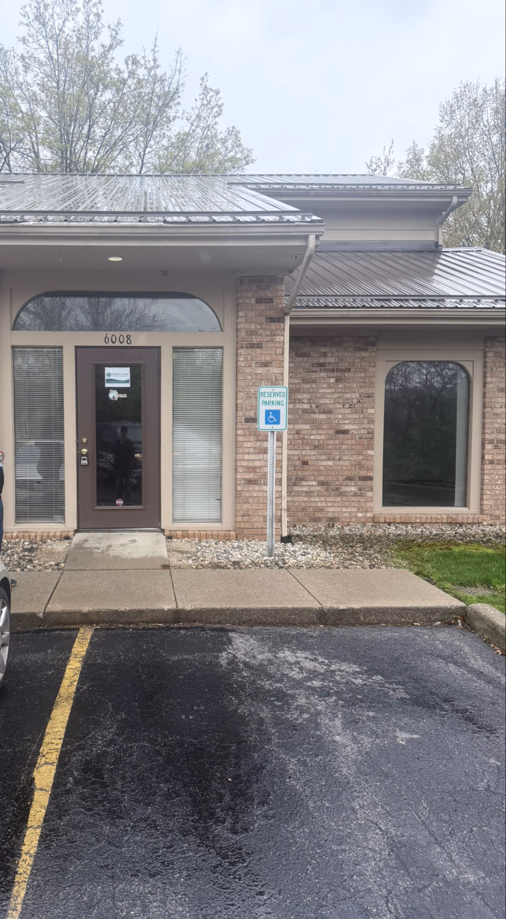 Front entrance of Fountain of Hope Home Care Services; handicap parking sign nearby.