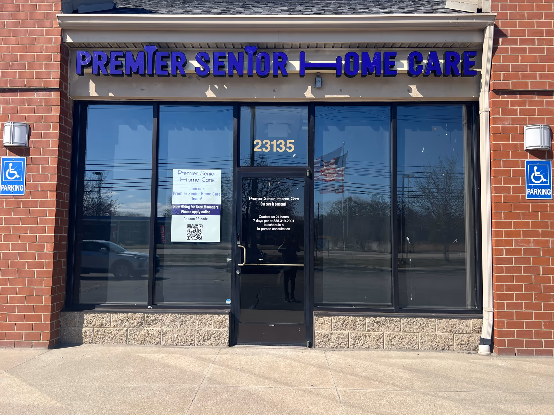 Exterior brick building with Premier Senior Home Care sign above glass entrance doors.